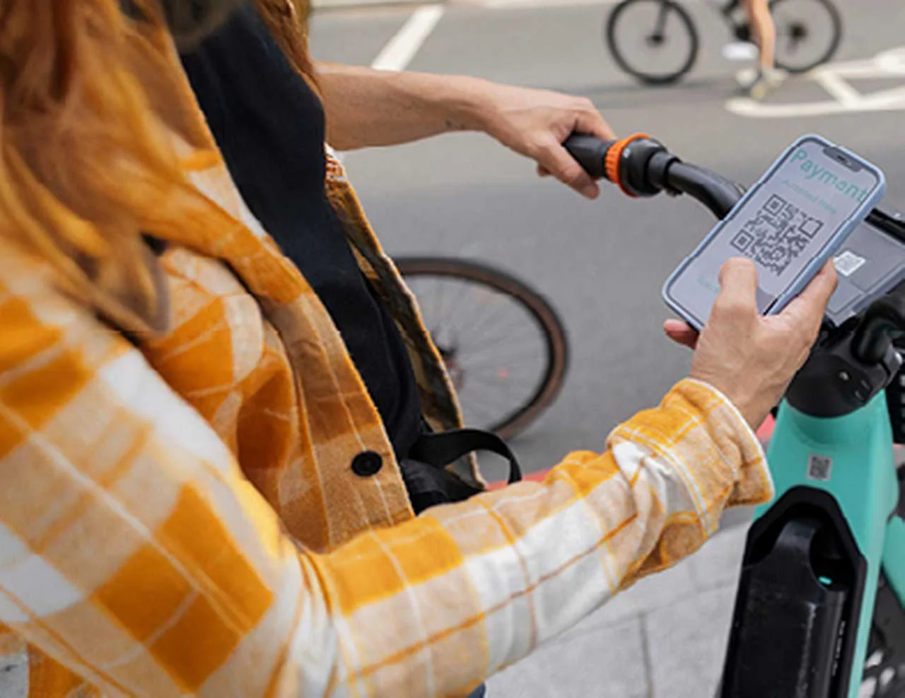 Woman scans a QR code on an e-scooter
